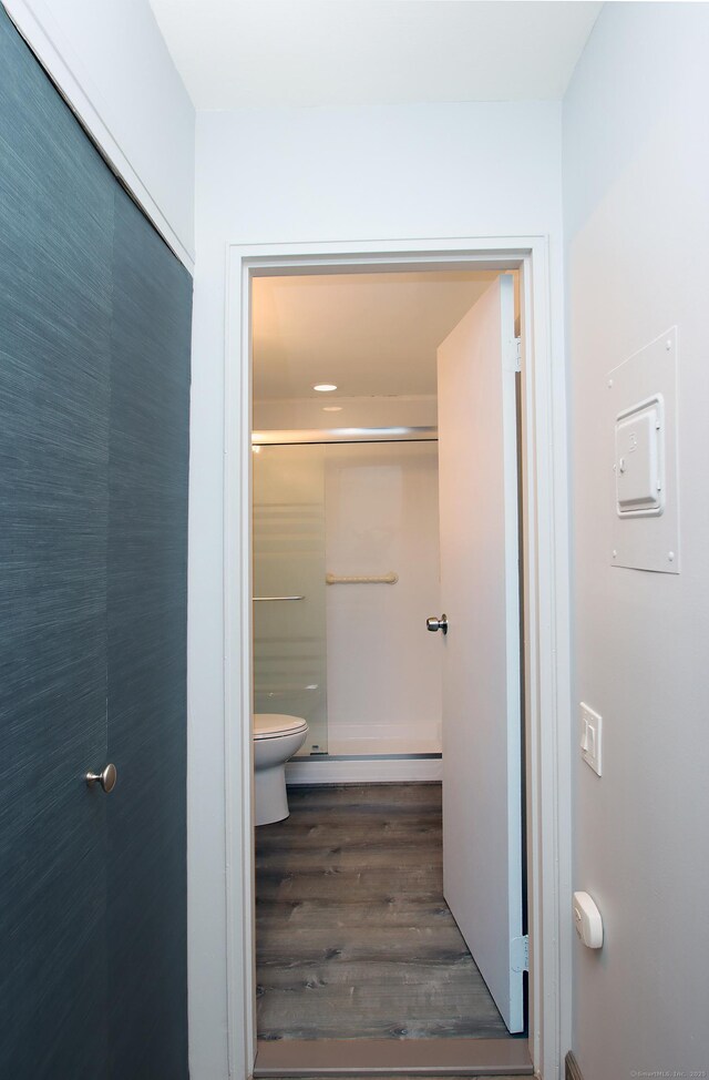 full bath featuring wood finished floors and toilet