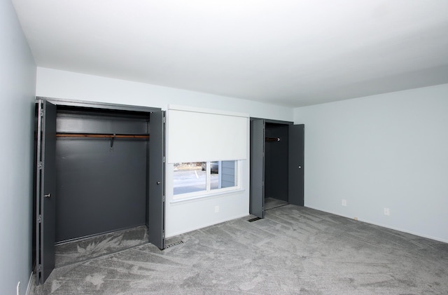 unfurnished bedroom featuring visible vents and light colored carpet