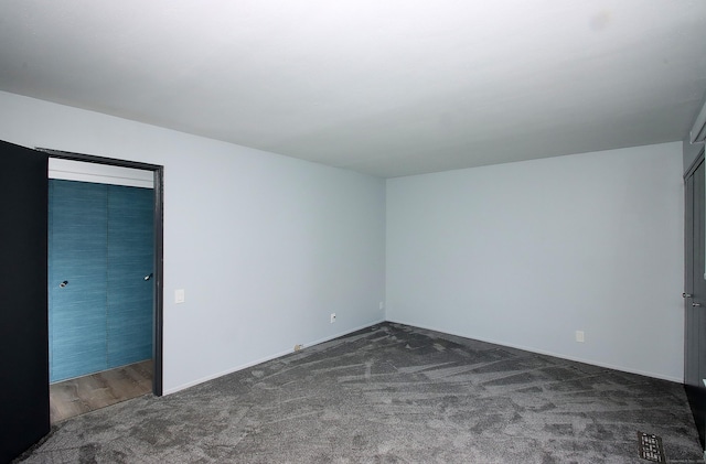 unfurnished bedroom featuring dark colored carpet