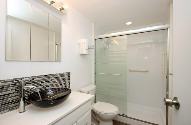 full bathroom with toilet, a shower stall, decorative backsplash, and vanity