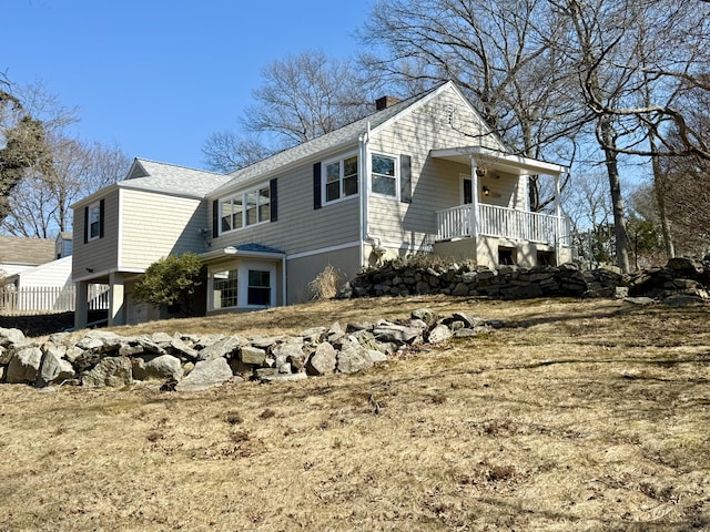 view of property exterior featuring a porch and a chimney