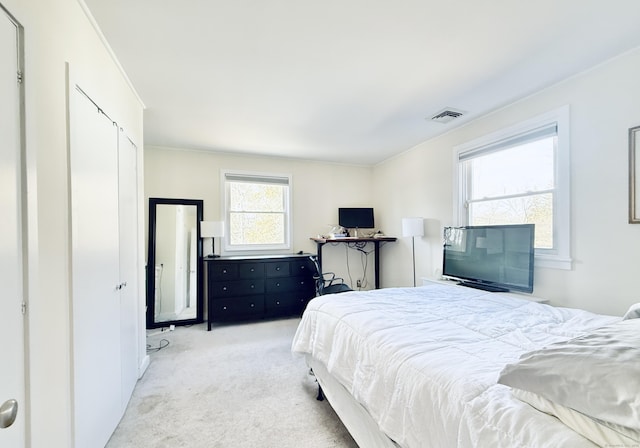 bedroom featuring light colored carpet and visible vents