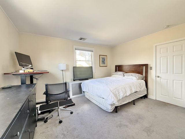 carpeted bedroom featuring visible vents and baseboards