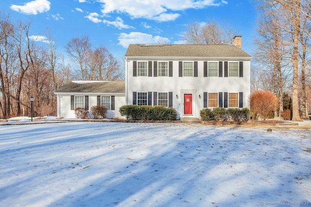 colonial home featuring a chimney