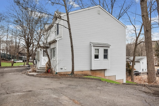 view of side of home with entry steps