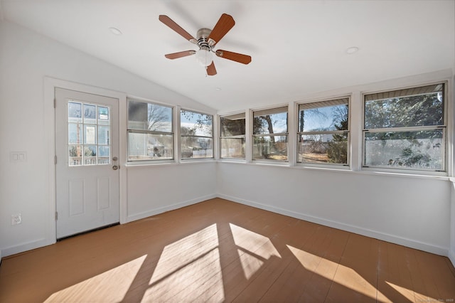 unfurnished sunroom with vaulted ceiling and a ceiling fan