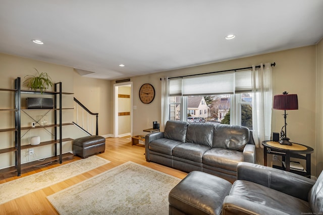 living room with stairs, recessed lighting, and wood finished floors