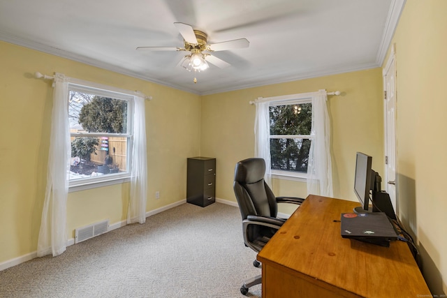 office with carpet floors, visible vents, ornamental molding, a ceiling fan, and baseboards