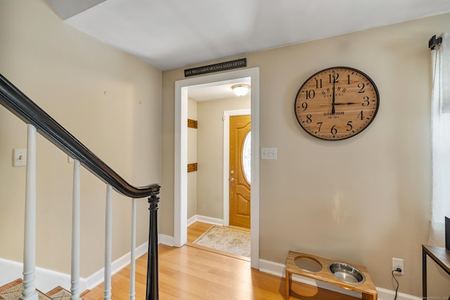 foyer featuring stairway, light wood-style flooring, and baseboards