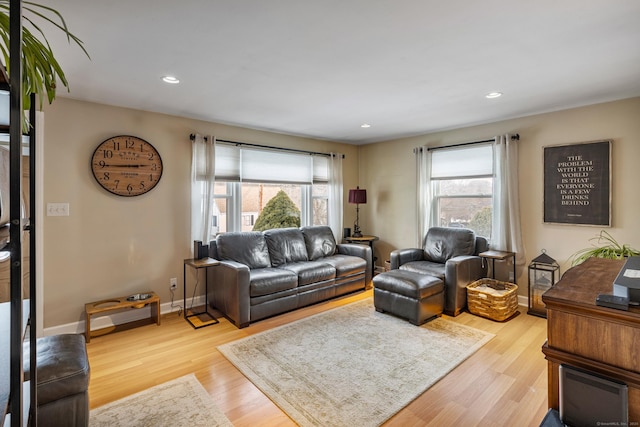 living area with light wood-type flooring, plenty of natural light, baseboards, and recessed lighting