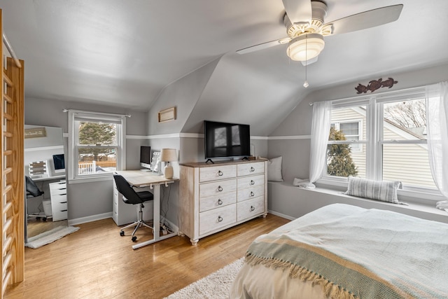 bedroom featuring a ceiling fan, light wood-type flooring, vaulted ceiling, and baseboards