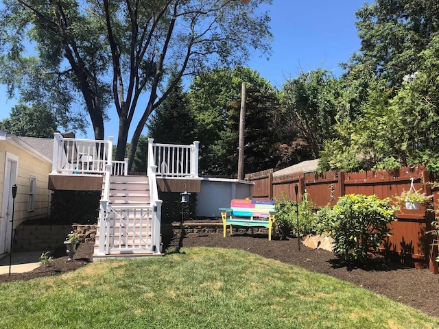 view of yard with stairs, fence, and a wooden deck