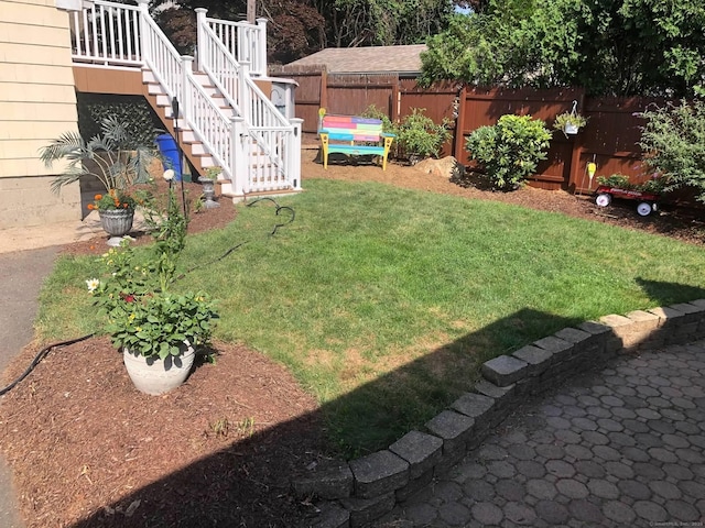 view of yard featuring stairs and fence