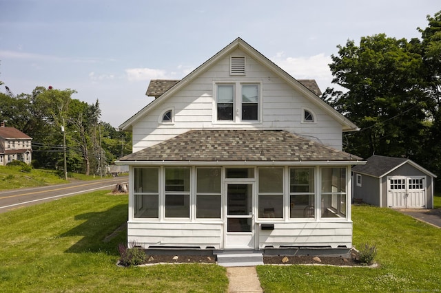 9 Crown St, Middletown, CT 06457 - view of front facade featuring a shingled roof, a sunroom, a front yard, and an outbuilding
