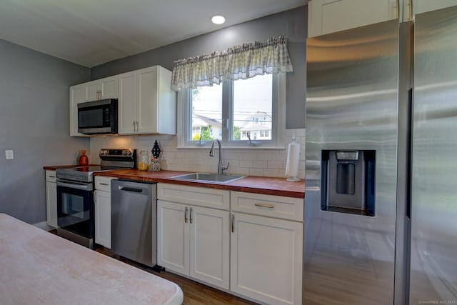 9 Crown St, Middletown, CT 06457 - kitchen with appliances with stainless steel finishes, butcher block counters, decorative backsplash, white cabinetry, and recessed lighting