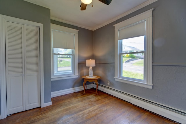 9 Crown St, Middletown, CT 06457 - bedroom with a baseboard heating unit, wood finished floors, crown molding, ceiling fan, and a closet