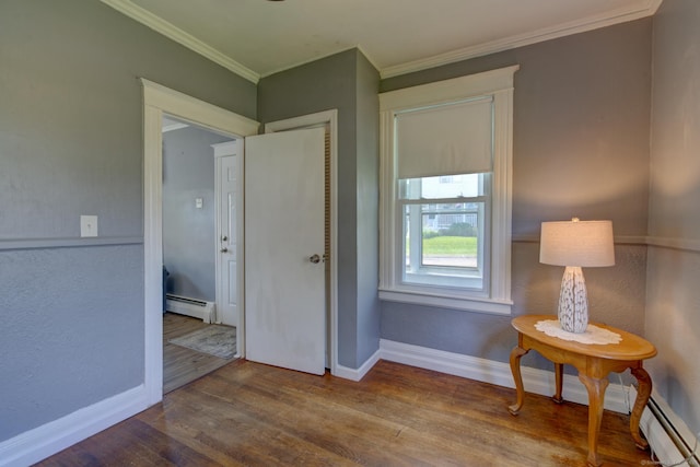 9 Crown St, Middletown, CT 06457 - living area with baseboard heating, wood finished floors, and ornamental molding