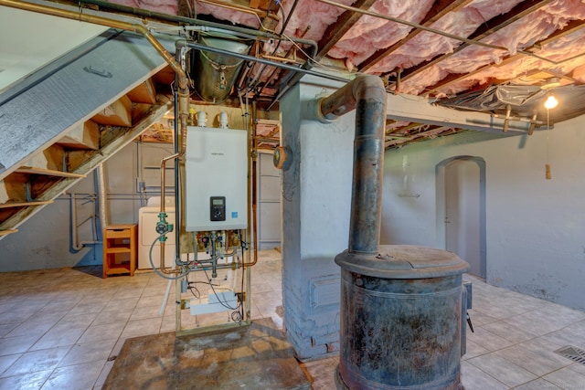 9 Crown St, Middletown, CT 06457 - unfinished below grade area with water heater, tile patterned flooring, arched walkways, and a wood stove