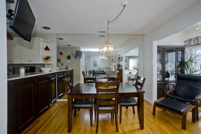 dining room featuring a chandelier and light wood-type flooring