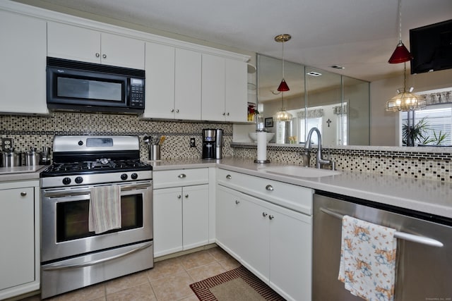 kitchen featuring stainless steel appliances, backsplash, plenty of natural light, and a sink