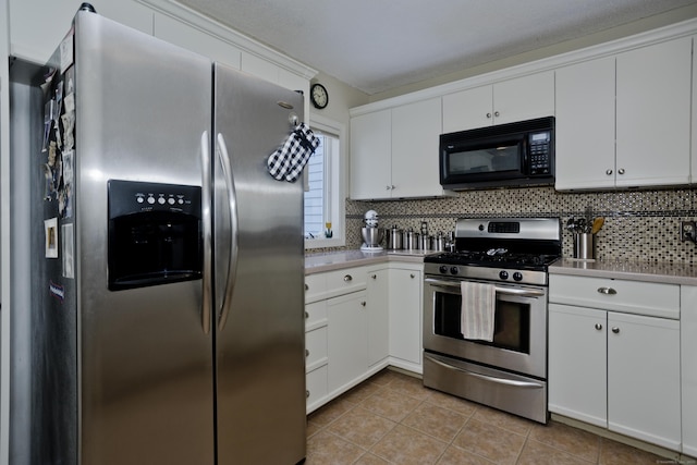 kitchen with appliances with stainless steel finishes, light tile patterned flooring, white cabinetry, and tasteful backsplash