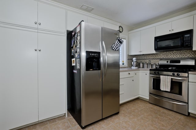 kitchen with light tile patterned flooring, white cabinetry, visible vents, appliances with stainless steel finishes, and decorative backsplash