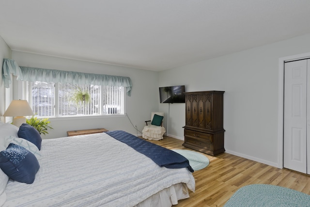 bedroom with baseboards and wood finished floors