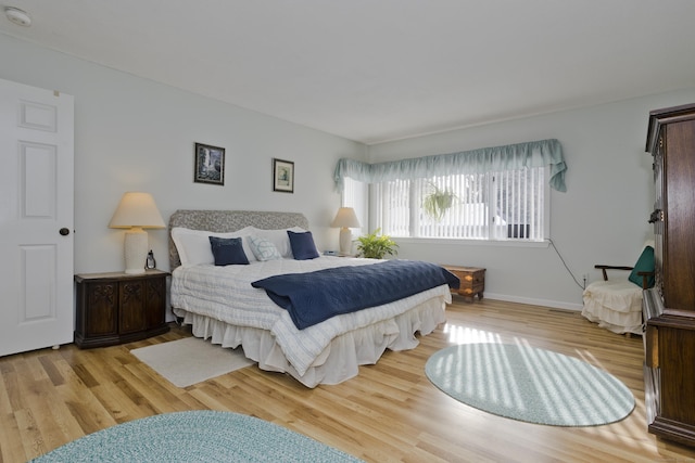 bedroom with wood finished floors and baseboards