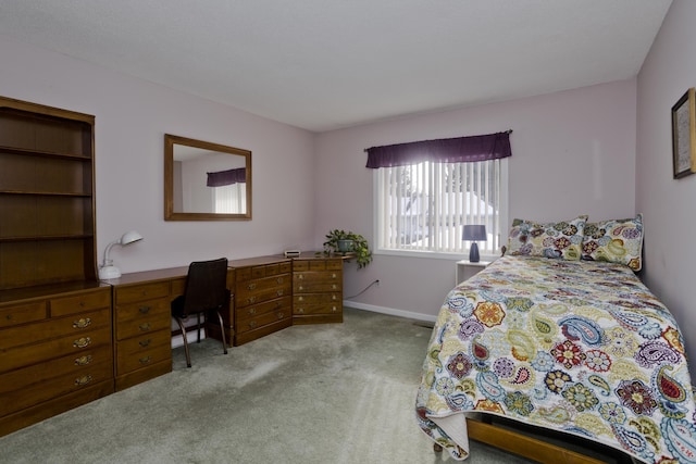 bedroom with carpet flooring and baseboards