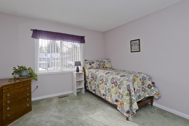 carpeted bedroom featuring visible vents and baseboards