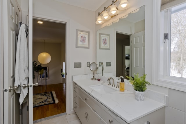 bathroom with tile patterned floors, a wealth of natural light, and vanity