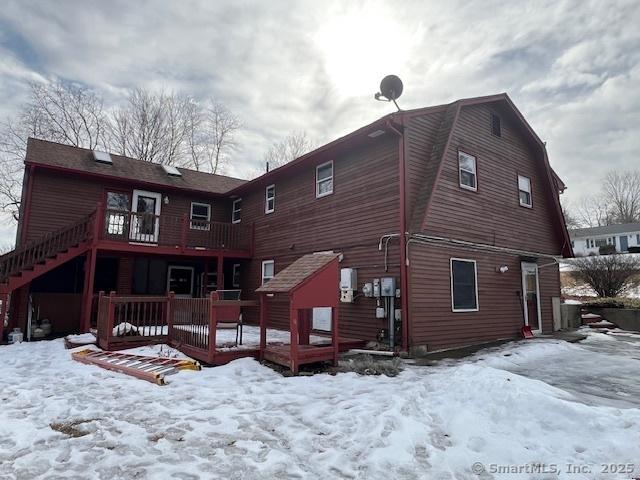 snow covered property featuring a wooden deck