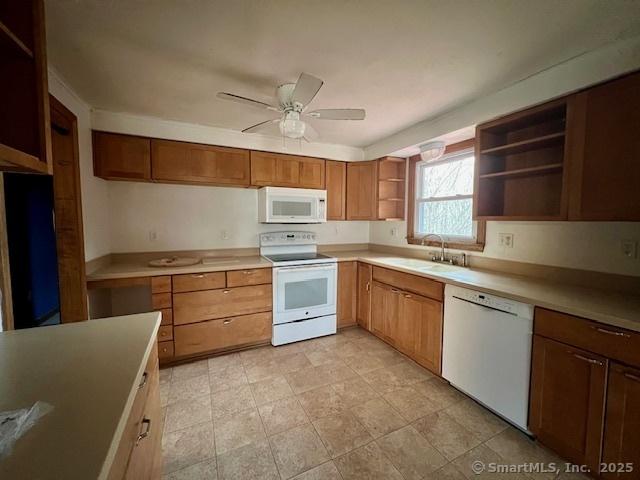 kitchen with white appliances, a ceiling fan, light countertops, open shelves, and a sink