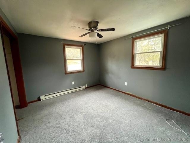 carpeted empty room featuring baseboards, a baseboard heating unit, and a ceiling fan