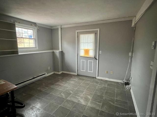 spare room with ornamental molding, a baseboard radiator, and baseboards