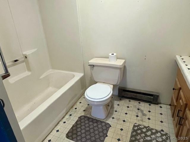 full bathroom with a baseboard radiator, vanity, and toilet