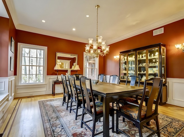 1 Wentworth Park, Farmington, CT 06032 - dining room with a chandelier, a wainscoted wall, light wood-type flooring, crown molding, and a decorative wall