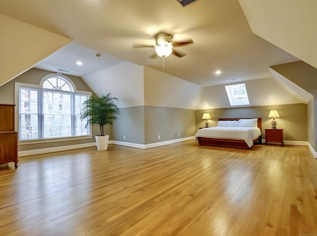 unfurnished bedroom with visible vents, baseboards, light wood-style flooring, recessed lighting, and lofted ceiling with skylight