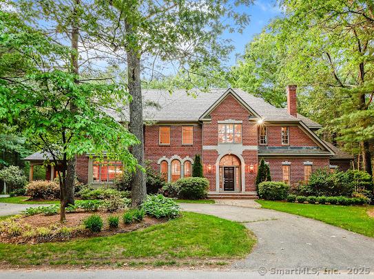 1 Wentworth Park, Farmington, CT 06032 - colonial home with brick siding, a chimney, curved driveway, and a front yard