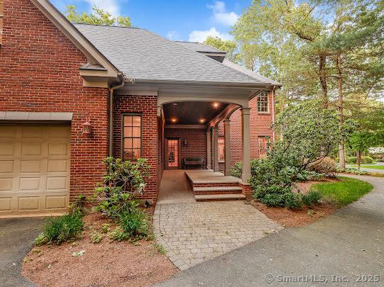 1 Wentworth Park, Farmington, CT 06032 - doorway to property featuring brick siding and roof with shingles