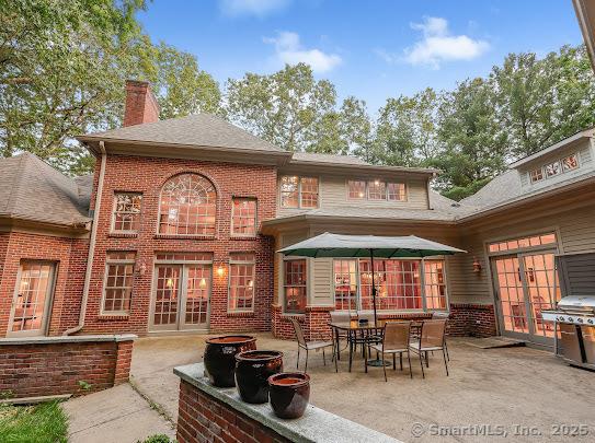 1 Wentworth Park, Farmington, CT 06032 - rear view of house featuring a patio, a chimney, french doors, brick siding, and roof with shingles