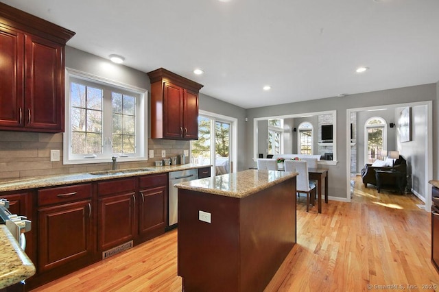 kitchen with a sink, dark brown cabinets, and dishwasher