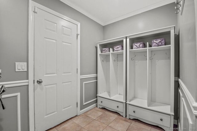 mudroom featuring light tile patterned flooring and ornamental molding