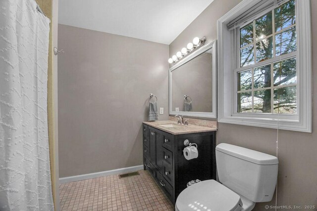 bathroom with tile patterned flooring, visible vents, baseboards, toilet, and vanity