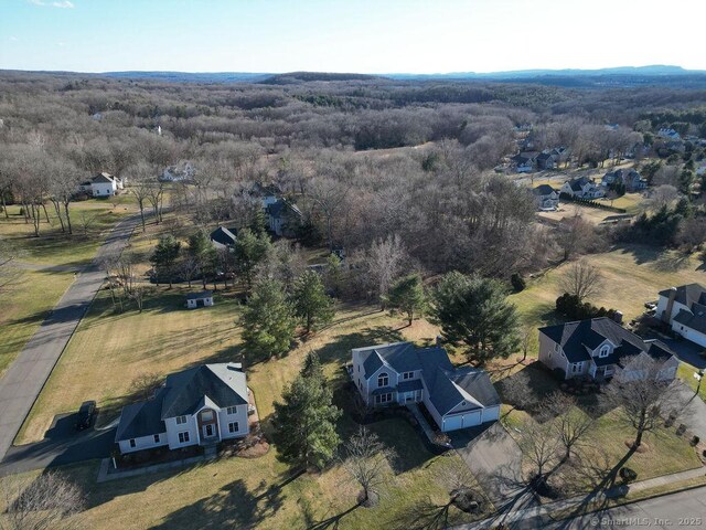 birds eye view of property featuring a view of trees