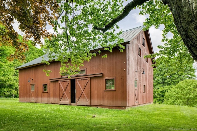 view of barn with a yard