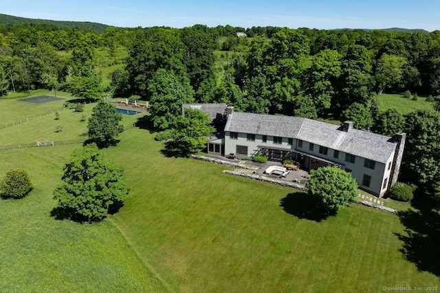 birds eye view of property with a view of trees