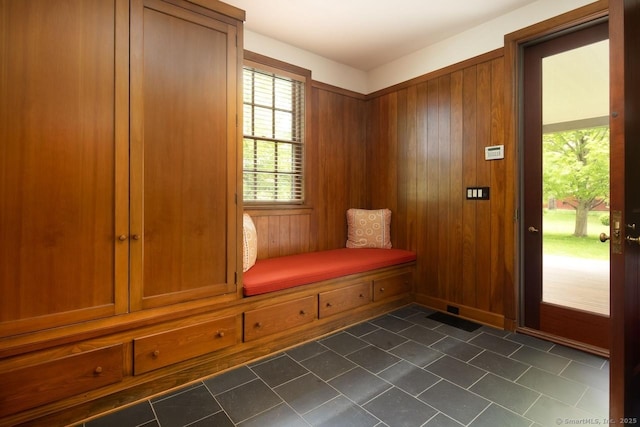 mudroom featuring wood walls