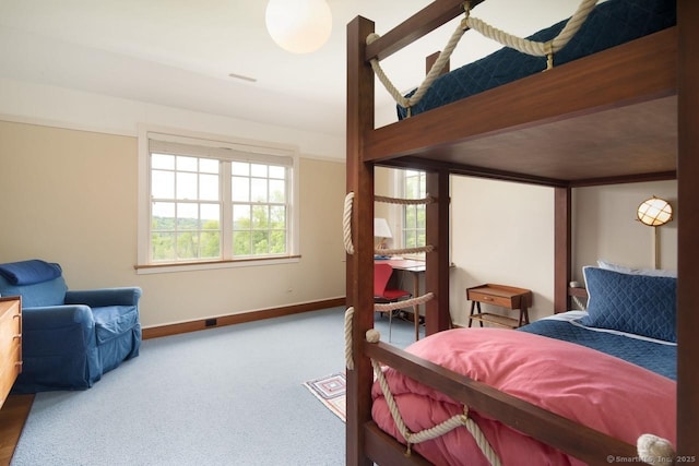 bedroom with carpet floors, visible vents, and baseboards