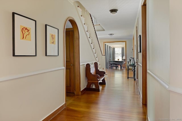 11 Valley Rd, Salisbury, CT 06039 - hall with baseboards, arched walkways, wood finished floors, and stairway